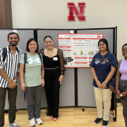 Giovanna Sagestegui (center) presents her poster and is pictured with Sanket Shinde, De-Fen Mou, Pritha Kundu, and Edith Ikuze.